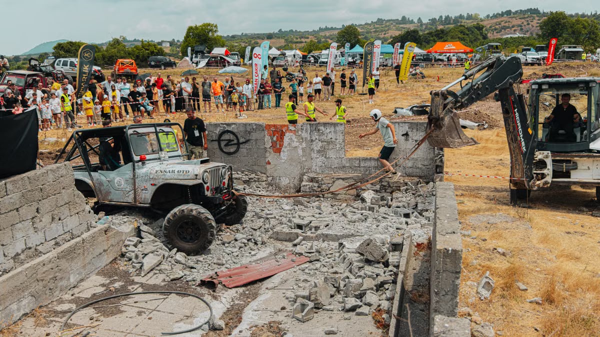 Dynamic scene of an offroad race with a Jeep and construction equipment navigating rubble, capturing action and adrenaline.